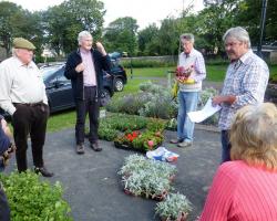 Rotary members getting ready to plant out the flower barrels